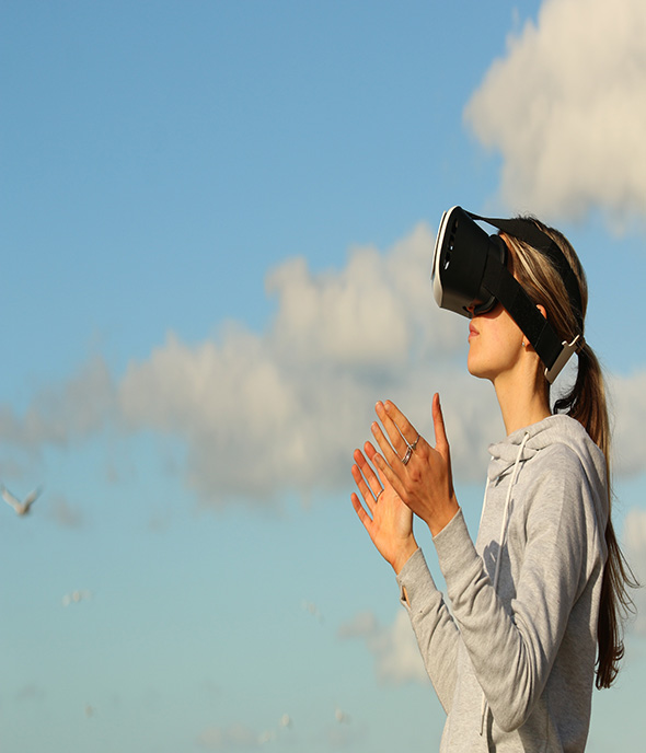 A girl is standing alone and yet enjoying using the augmented reality